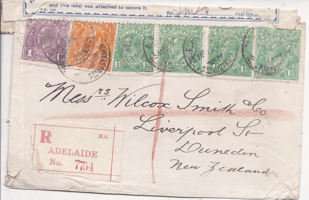 Australia Unclearly dated registered cover to Dunedin, New Zealand franked KGV Heads 1/2d.,1d. and 1 1/2d. (4) tied Adelaide cds, Officially Sealed label applied on arrival as found torn