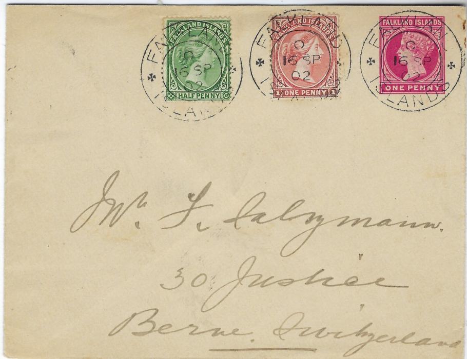 Falkland Islands 1902 One Penny postal stationery envelope uprated with 1/2d. and 1d. each tied by good clear double-ring Falkland Islands cds, Swiss arrival backstamp.