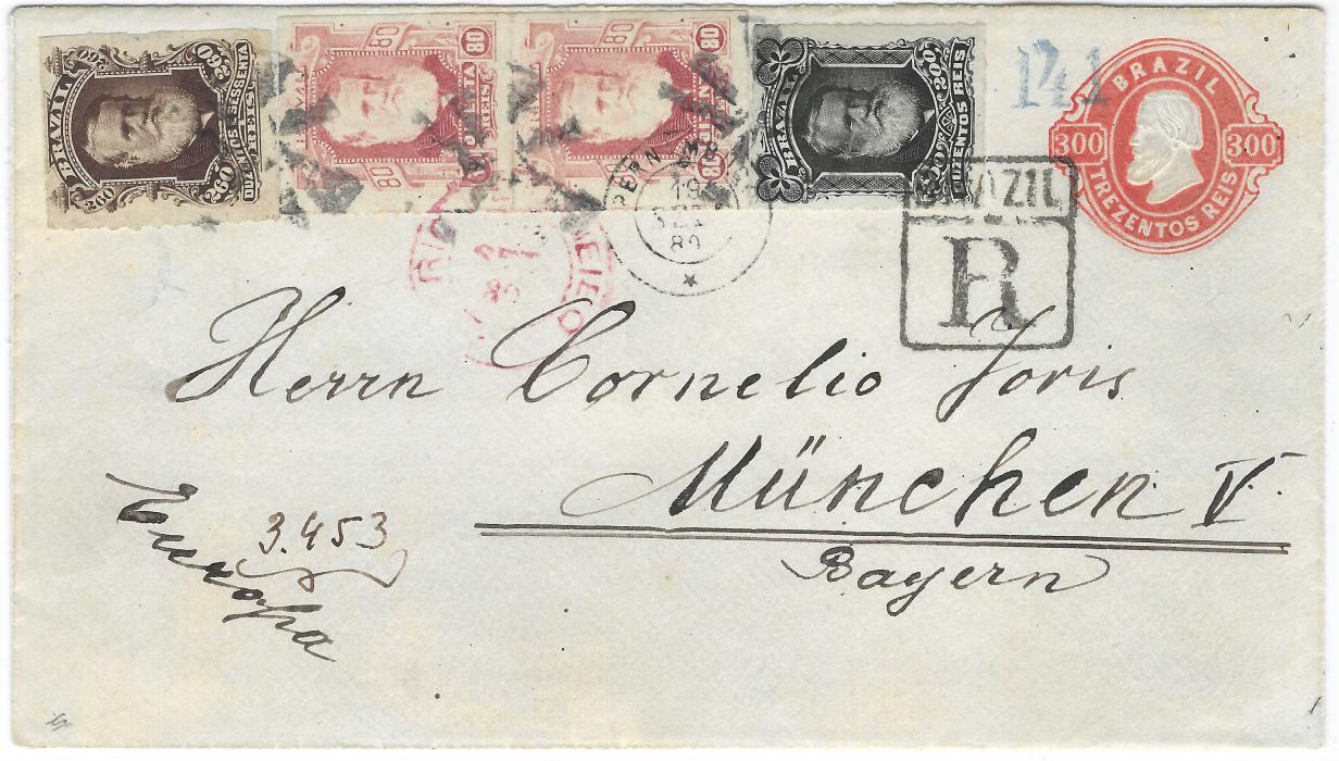 Brazil 1889 300r. postal stationery envelope to Munich, Germany uprated 1878-79 rouletted 80r. vertical pair, 200r. black and 260r. brown tied by three ornate cork handstamps, small double-ring Pernambuco cds and red Rio De Janeiro transit, the 200r. additionally tied by registration handstamp, arrival backstamp. A very fine franking.