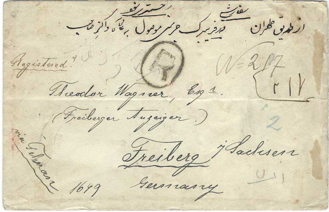 Persia 1897 registered cover to Freiburg franked on reverse with mixed issue franking with 2ch and 5ch ‘Lion’ plus Nasr-ed-Din Shah 20ch. (2) and 1Kr. tied Boushir cds, Teheran transit and arrival cancel; an overfranked cover with vertical and horizontal creasing and a little grubby.