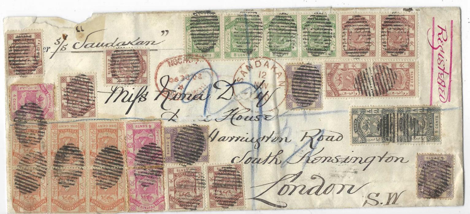 North Borneo 1890 (12 Nov) envelope (250 x 110mm) registered from Sandakan to London, bearing 1886-87 1c. block of 6 and two pairs (both on reverse), 2c. (9 including 2 pairs), 5c (4, a pair on reverse), 8c strip of four and 1889 3c. (5, a pair on reverse) and 5c. (5, three on reverse), all cancelled by 14 bar oval, showing red depatch and arrival datestamp (20.12.) on reverse, framed 