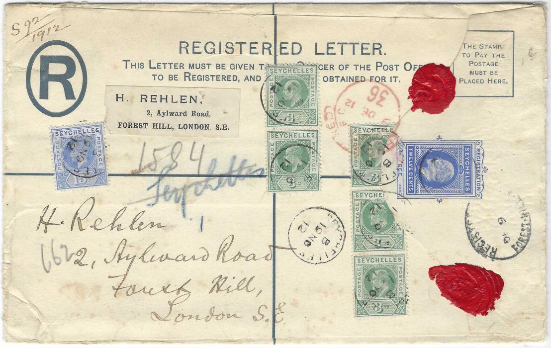 Seychelles 1912 (19 NO) size H 12c registered stationery envelope to London additionally franked KEVII 3c. (5) and 15c., the top stamp in 3c. vertical pair with dented frame variety, the flap of envelope is on top of the other strip; some slight peripheral faults to envelope