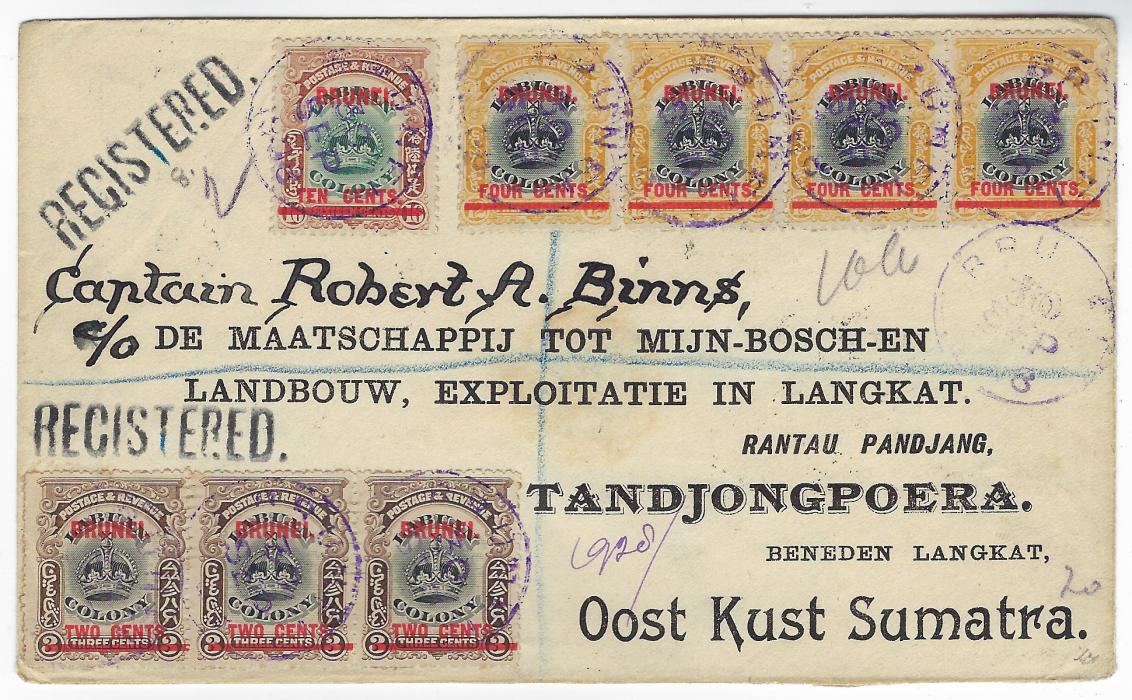 Brunei 1909 (30 Sep) registered printed envelope to Tandjongpoera, Netherland East Indies franked Labuan 2c on 3c horizontal strip of three, 4c horizontal strip of four and single 10c on 16c all overprinted BRUNEI in red, tied by BRUNEI cds in violet, registration handstamp in same ink on reverse, also showing Labuan cds, Singapore cds (OC 12), Postagent Singapore cds (12 Oct) and arrival cds (16 Oct); a fine, striking envelope, Ex. Besancon.