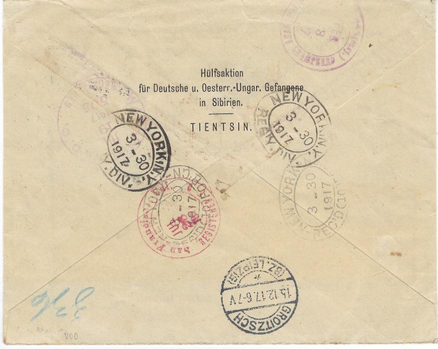 China (German Post Offices) 1917 (21.2.) ‘SERVICE DES PRISONNIERS DE GUERRE’ part printed stampless envelope registered to Germany bearing Tientsin Deutsche Post despatch, violet registration bottom left, British PASSED BY CENSOR/TIENTSIN handstamp, routed to go via America where violet return cachets added at New York, the envelope then with added handstamp of Danish P.O.W. Agency and sent again with San Francisco cds of Jul 26, handstamped in Copenhagen 21. Nov and final Groitzsch arrival (15.12.).Opened for display as usual.