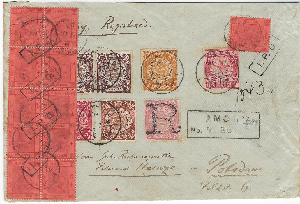 China 1899 (17 Aug) registered cover to Potsdam, Germany bearing Coiling Dragon values including $1 Goose tied by neat bilingual Amoy cds, the 5c. cancelled only by ‘R’ handstamp with registration handstamp to right, additionally franked for overseas postage with Hong Kong 10c. purple/red single and blocks of four and six with distinctive framed I.P.O. handstamps of Amoy, additionally cancelled in Hong Kong, arrival backstamp. Without backflap and some slight soiling not detracting from fine appearance, The $1 a rare stamp on cover.