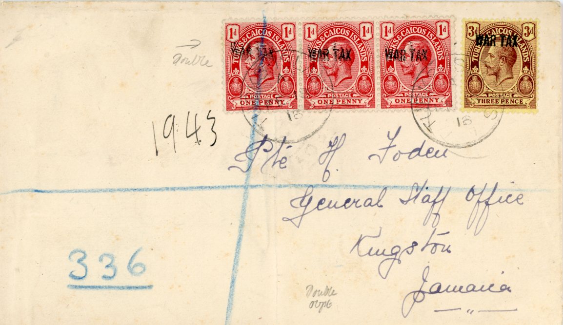 TURKS and CAICOS ISLANDS TURKS and CAICOS ISLANDS: 1918 (FE 18) registered envelope to Jamaica franked 1917 WAR TX ovpts. on 1d red horizontal strip of 3 + 3d, 1d strip showing obvious double ovpt., most notably on the left hand adhesive, all stamps tied by Turks Islands cdss, New York transit bss (2 28) and Kingston arrival, central vertical crease appears to go under the left hand stamp (presumably cover was creased before usage), stamp also tied by blue crayon registration crayon, very scarce usage.